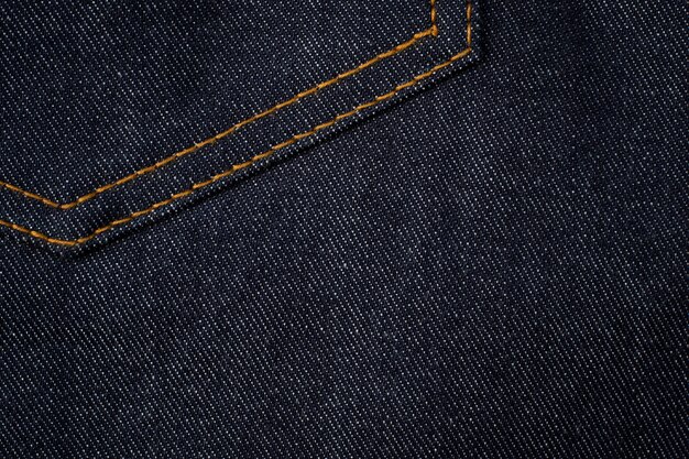 Fond de texture jeans bleu foncé avec poche.