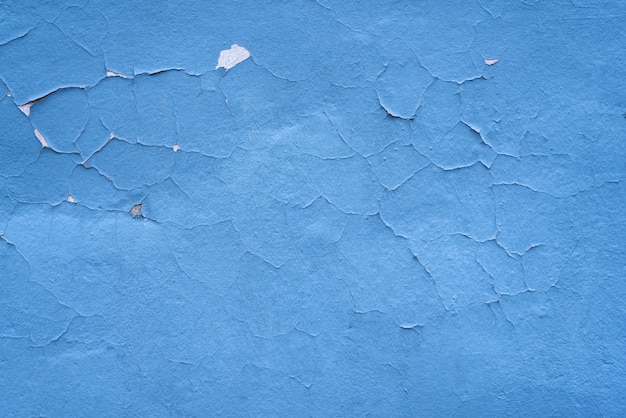 Fond de texture minable bleu. Mur de peinture fissuré.