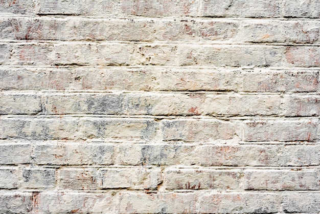 Fond de texture de mur de brique. Texture de brique avec des rayures et des fissures