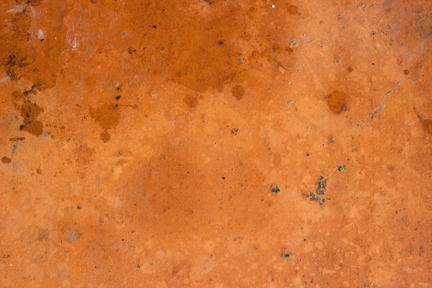 Fond de texture de mur de ciment orange-brun