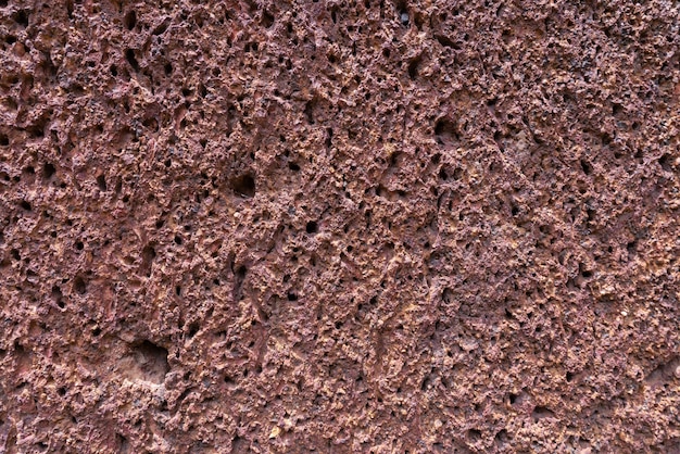 Fond de texture de mur de pierre de latérite rouge