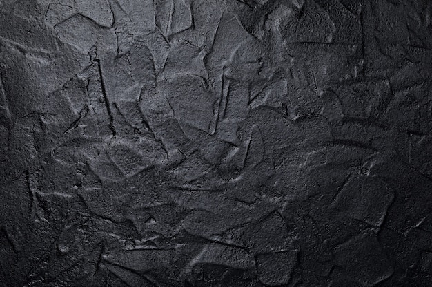 Fond de texture de mur plâtré art noir ou gris foncé