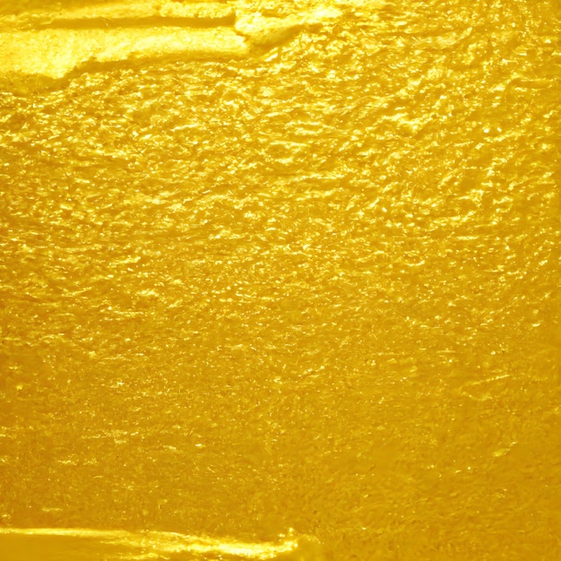 Fond de texture or gros plan d'une surface brillante d'or matériau lisse doré feuille d'or IA générative