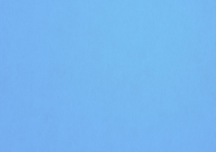 Photo fond de texture de papier bleu pâle. papier peint vierge propre