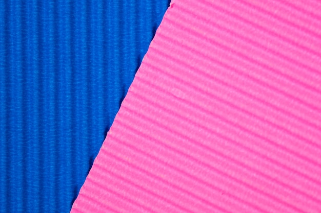Fond de texture de papier ondulé bleu et rose.