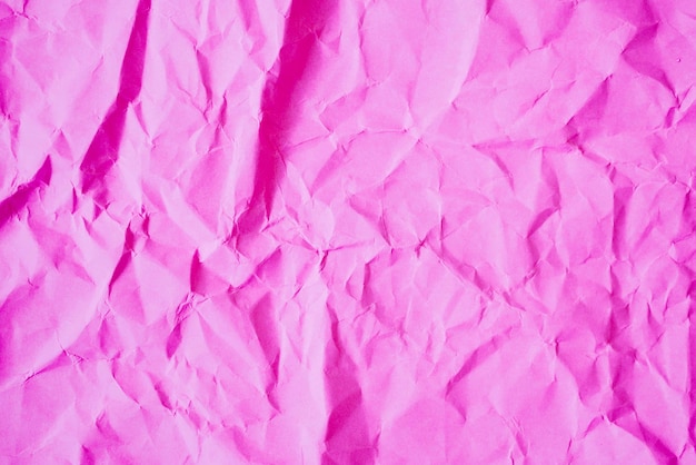 Fond de texture de papier rose froissé