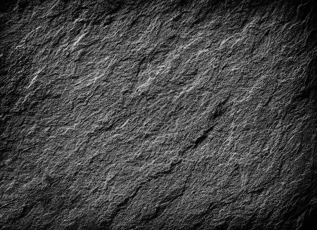 Fond de texture de pierre granuleuse rugueuse noir ou gris foncé