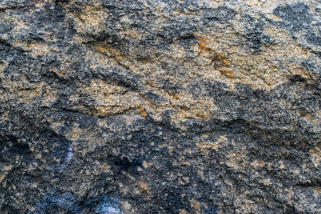 Fond de texture de roche de granit gris brut Fragment de mur en pierre naturelle