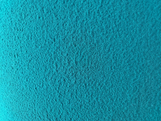 Un fond texturé rugueux turquoise avec une texture givrée