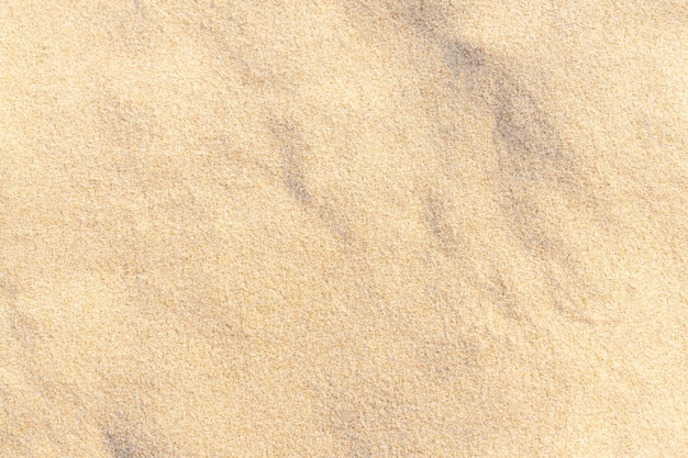Photo fond de texture de sable sur la plage. modèle de texture de sable de mer beige clair, fond de plage de sable.
