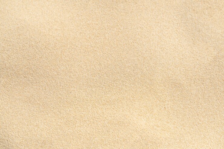 Photo fond de texture de sable sur la plage. modèle de texture de sable de mer beige clair, fond de plage de sable.
