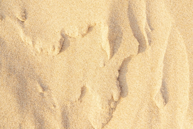 Fond de texture de sable sur la plage. Motif de texture de sable de mer beige clair, fond de plage de sable.