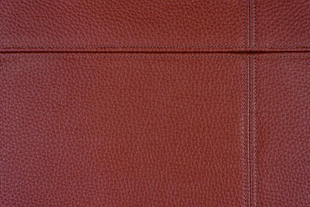Fond de texture en simili cuir rouge avec coutures décoratives