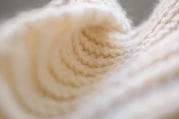 Photo fond de texture de tissu de laine tricoté beige gros plan