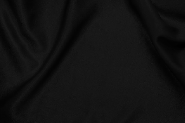 Fond de texture de tissu noir, motif froissé de soie ou de lin.