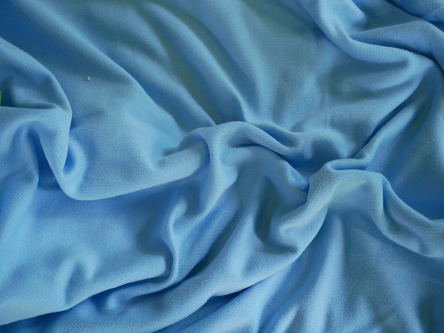 Photo fond de texture de tissu de soie bleue, vêtements de sport, fond bleu