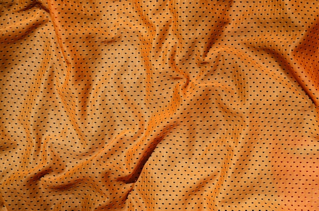 Fond de texture tissu sport orange vêtements. Vue de dessus