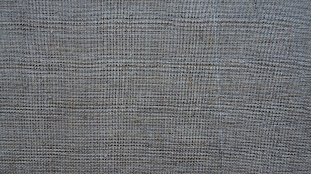 Fond de texture de tissu tissu gris avec tissage aspect naturel légèrement froissé du matériau unif