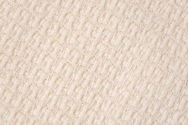 Fond de texture de tissu tricoté beige Gros plan