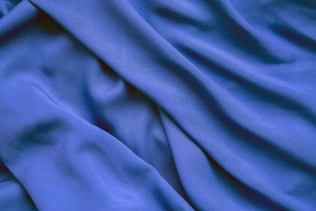 Fond de tissu bleu en plis La texture du tissu