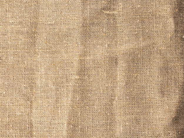 Fond de tissu rugueux fait de toile de jute texturée marron