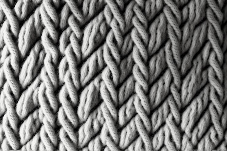 Photo fond de tissu en tricot de laine gris clair tacheté sans couture.