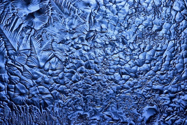 Photo fond de verre de glace bleue, texture abstraite de la surface de la glace sur le verre, eau saisonnière gelée