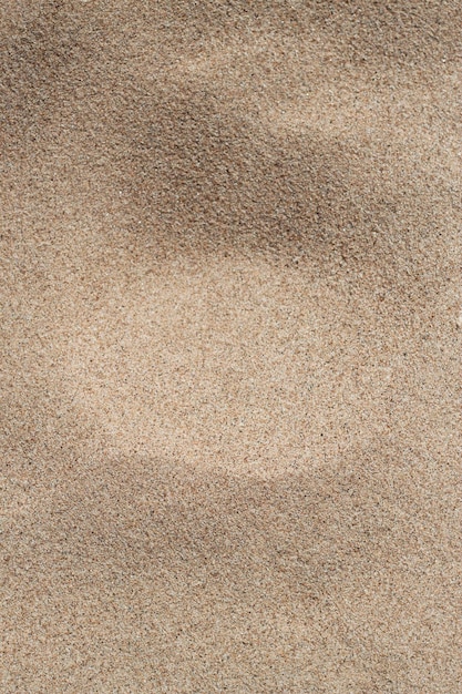 Photo fond vertical avec du sable de plage jaune