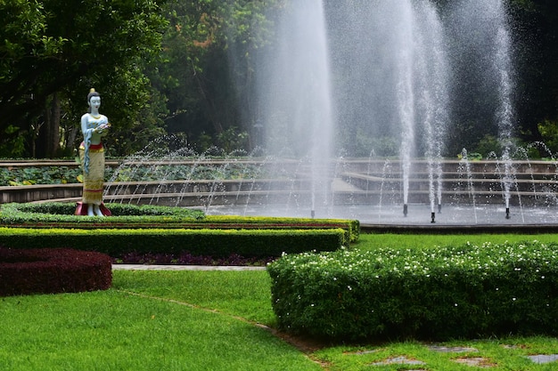 La fontaine est une belle fontaine dans le jardin avec pelouse