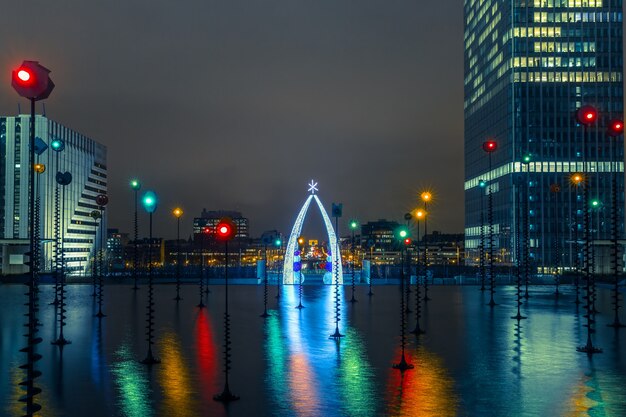 Photo fontaine multicolore dans l'esplanade de la défense la nuit, paris, france