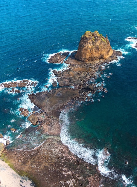 Photo une formation rocheuse dans l'océan avec la mer en arrière-plan