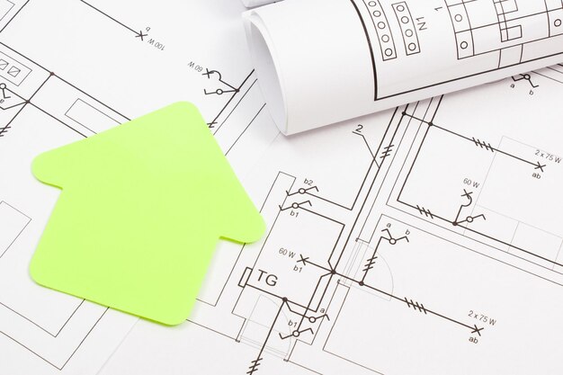 Photo forme de maison en papier et plan de logement électrique concept de construction de maison