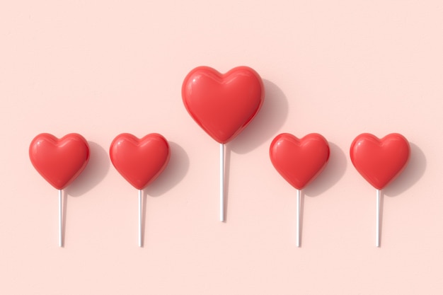 Formes exceptionnelles de coeur rouge de sucette de bonbons sur fond rose. Rendu 3D. Idée de concept minimal pour la Saint-Valentin.