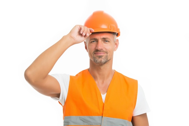 Fort beau constructeur Bon travail La sécurité est le point principal Le constructeur de l'homme porte un casque de protection et un fond blanc uniforme Constructeur de travailleurs confiant regardant la caméra Concept d'équipement de protection