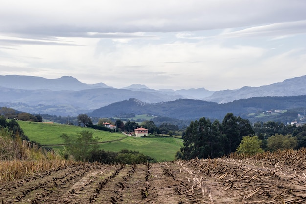 Fotografia de paisaje con huerta casitas y preciosas montanas al fondo