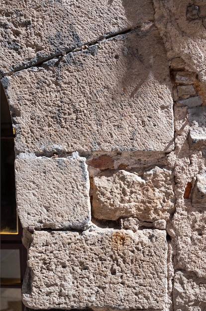 Photo fragment d'ancien mur de pierre surface à texture rugueuse mur d'une vieille maison