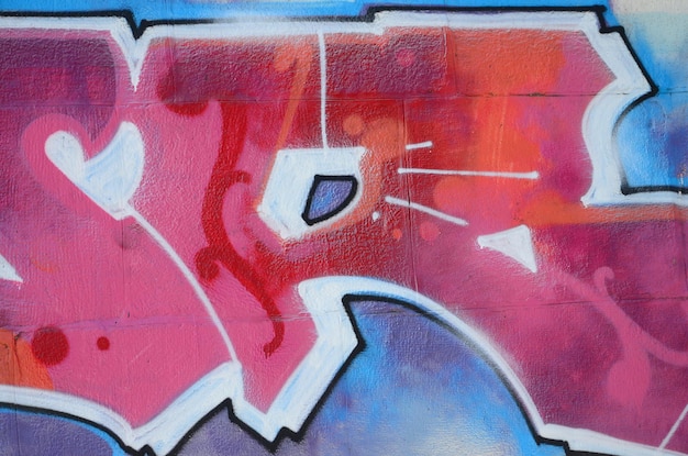 Fragment de dessins de graffitis Le vieux mur décoré de taches de peinture dans le style de la culture de l'art de la rue Texture de fond colorée dans des tons chauds