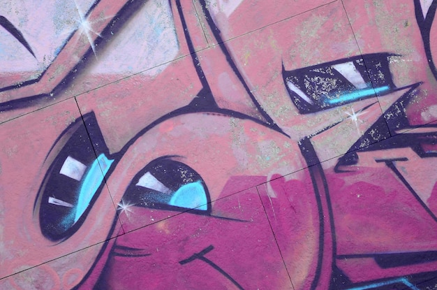 Fragment de dessins de graffitis Le vieux mur décoré de taches de peinture dans le style de la culture de l'art de rue Texture de fond colorée dans des tons chauds