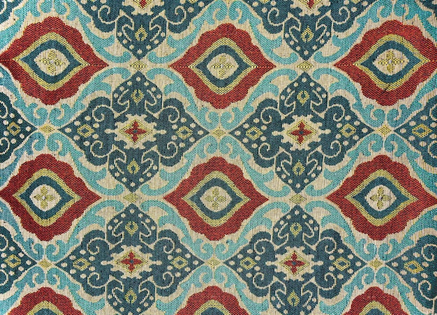 Photo fragment de motif textile de tapisserie rétro coloré avec ornement floral utile comme arrière-plan photo de haute qualité