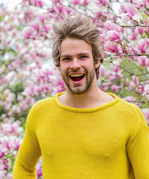 Fraîcheur et réveil Inspiration printanière Avril mai Joie du printemps Homme fond de fleurs Beauté printanière Hipster profiter de la fleur Concept de printemps Guy se détendre dans le parc de fleurs Jardin botanique