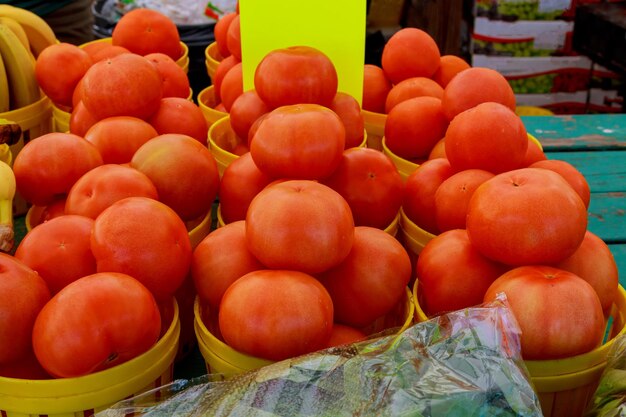 Frais de la ferme affiche du tableau de craie avec des paniers pleins de tomates rouges cultivées localement à loca