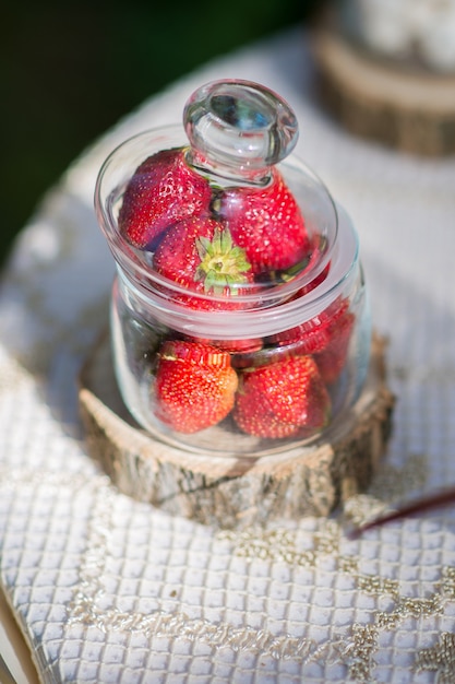 Fraises fraîches, dans un bocal en verre sur la table