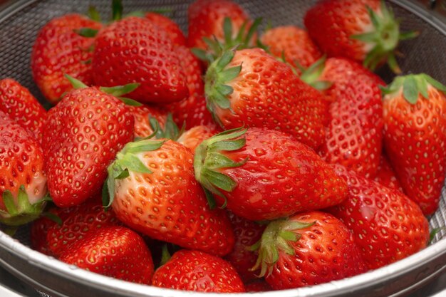 Fraises fraîches dans un panier sur fond blanc