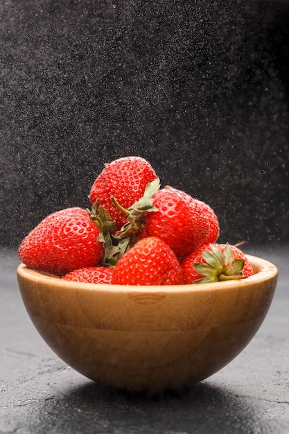 Fraises mûres dans un bol en bois