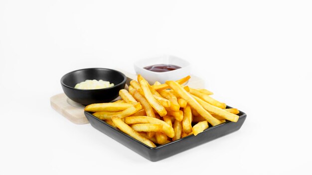 Photo frites ou croustilles avec sauces crème et ketchup sur fond blanc mise au point sélective