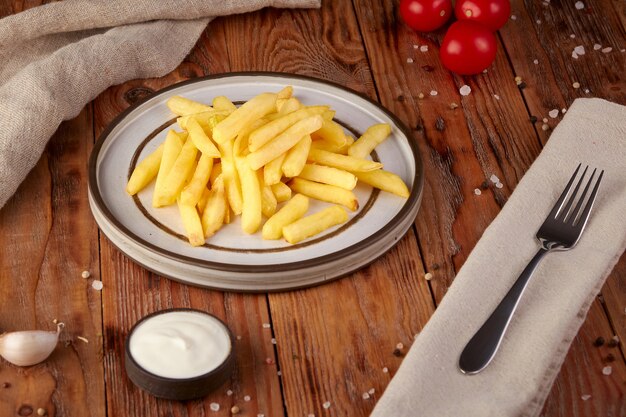 Frites avec sauce, fond en bois