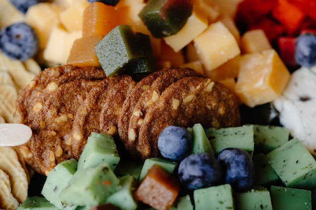 Fromage appétissant en combinaison avec des fruits et des biscuits