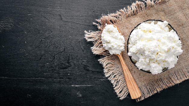 Fromage caillé sur un fond en bois noir Vue de dessus Espace libre