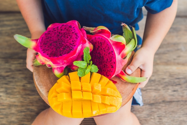 Fruit du dragon en dés et mangue sur une plaque en bois