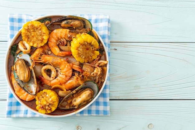 fruits de mer épicés au barbecue - crevettes, calmars, moules et maïs